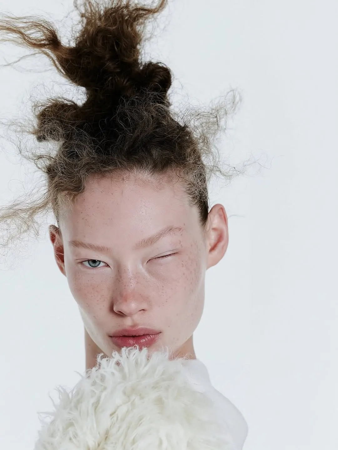 Close portrait with wild swept hair and bleached brows